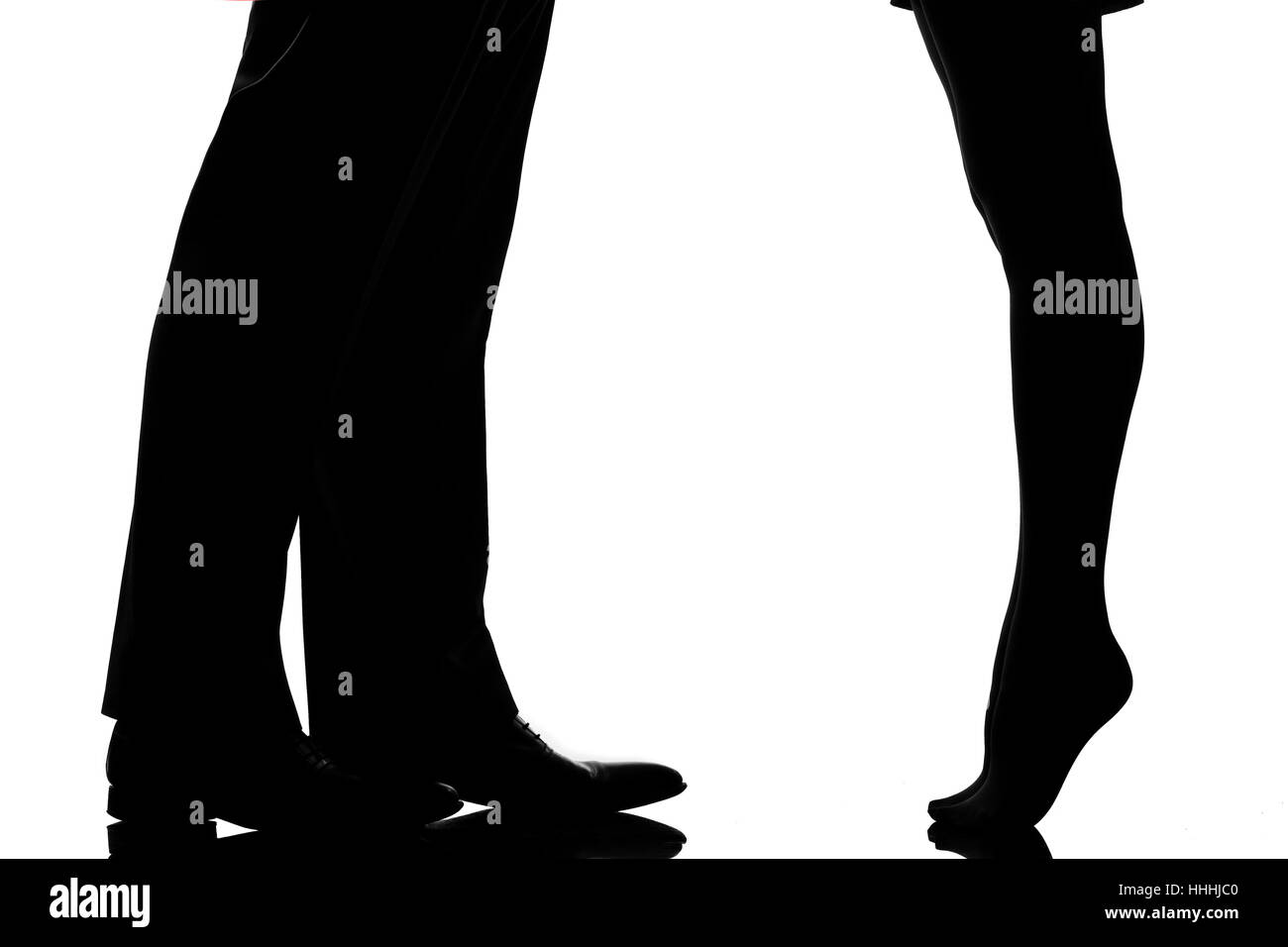 one caucasian detail legs feet couple man and woman tiptoe lovers teenderness in studio silhouette isolated on white background Stock Photo