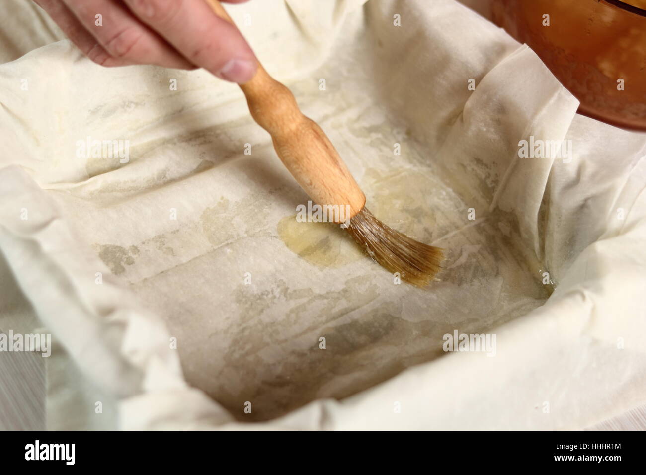 Brushing filo pastry sheet with butter. Making Potato and Leek Filo Pie. Series. Stock Photo