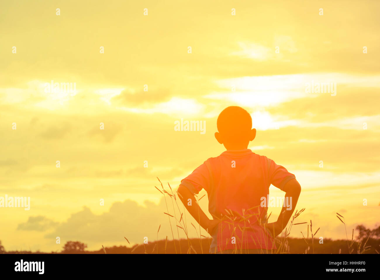 Child asian looking sunshine view.Child lonely and sad with mountain view in holiday. Stock Photo