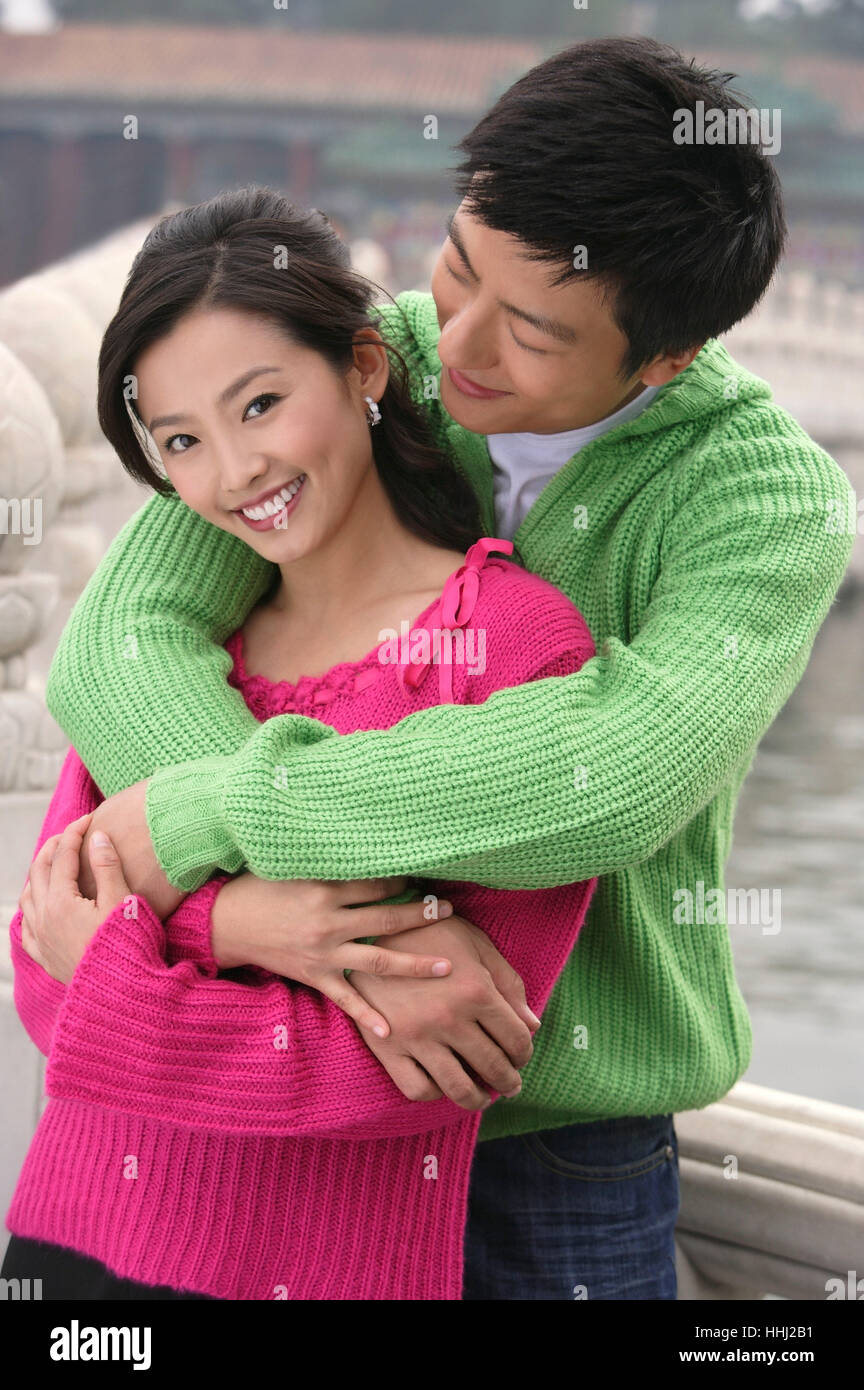 A couple smile as they have their arms around each other Stock Photo ...