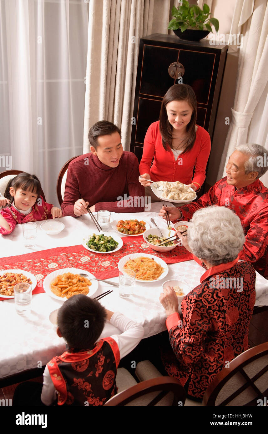 Family At Dinner Table Having Traditional Food Stock Photo Alamy