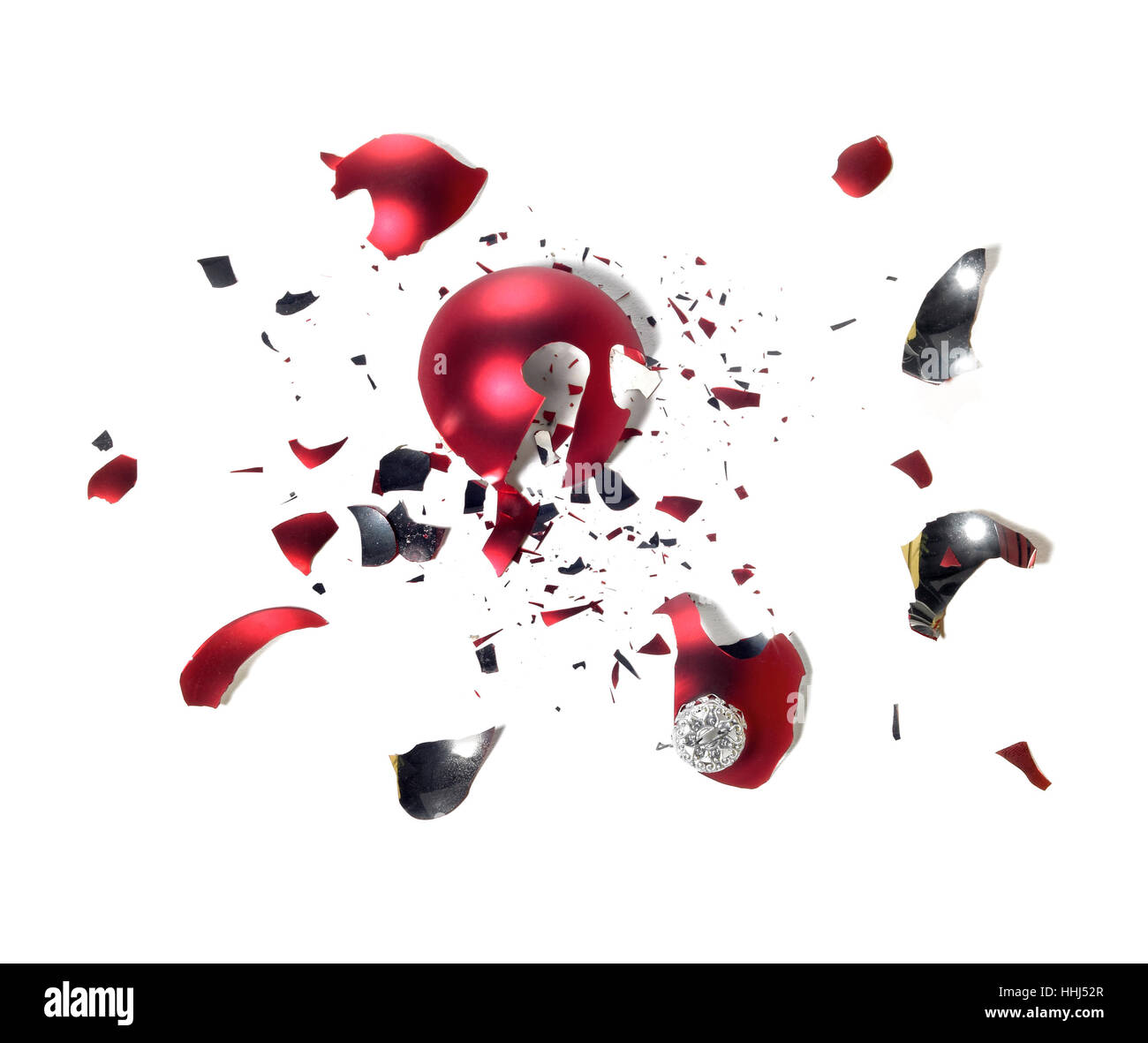 studio photography of a broken red christmas tree ball with lots of shards on the ground in white back Stock Photo