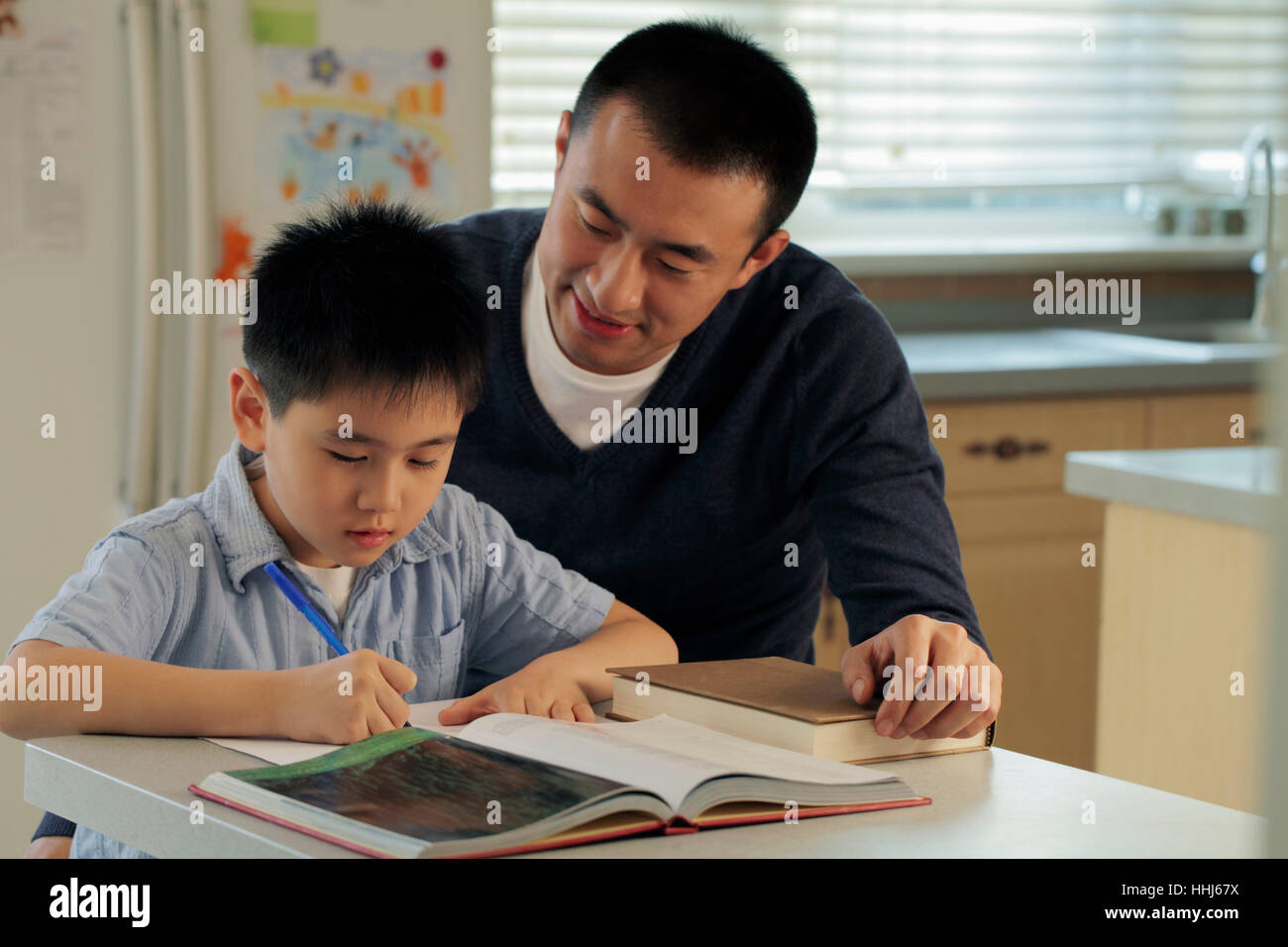 Father helping son with his homework Stock Photo - Alamy