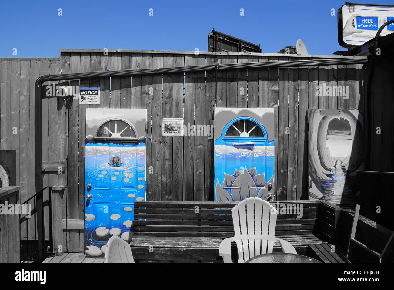 2 Blue Doors Artistically Painted with a Blue Sky Background - Black and White and Blue Stock Photo