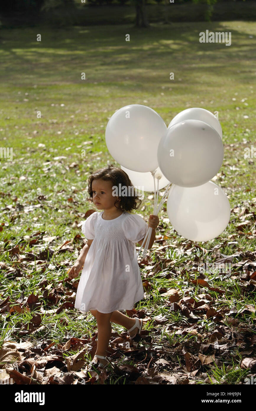 Girl in park, with balloons Stock Photo - Alamy