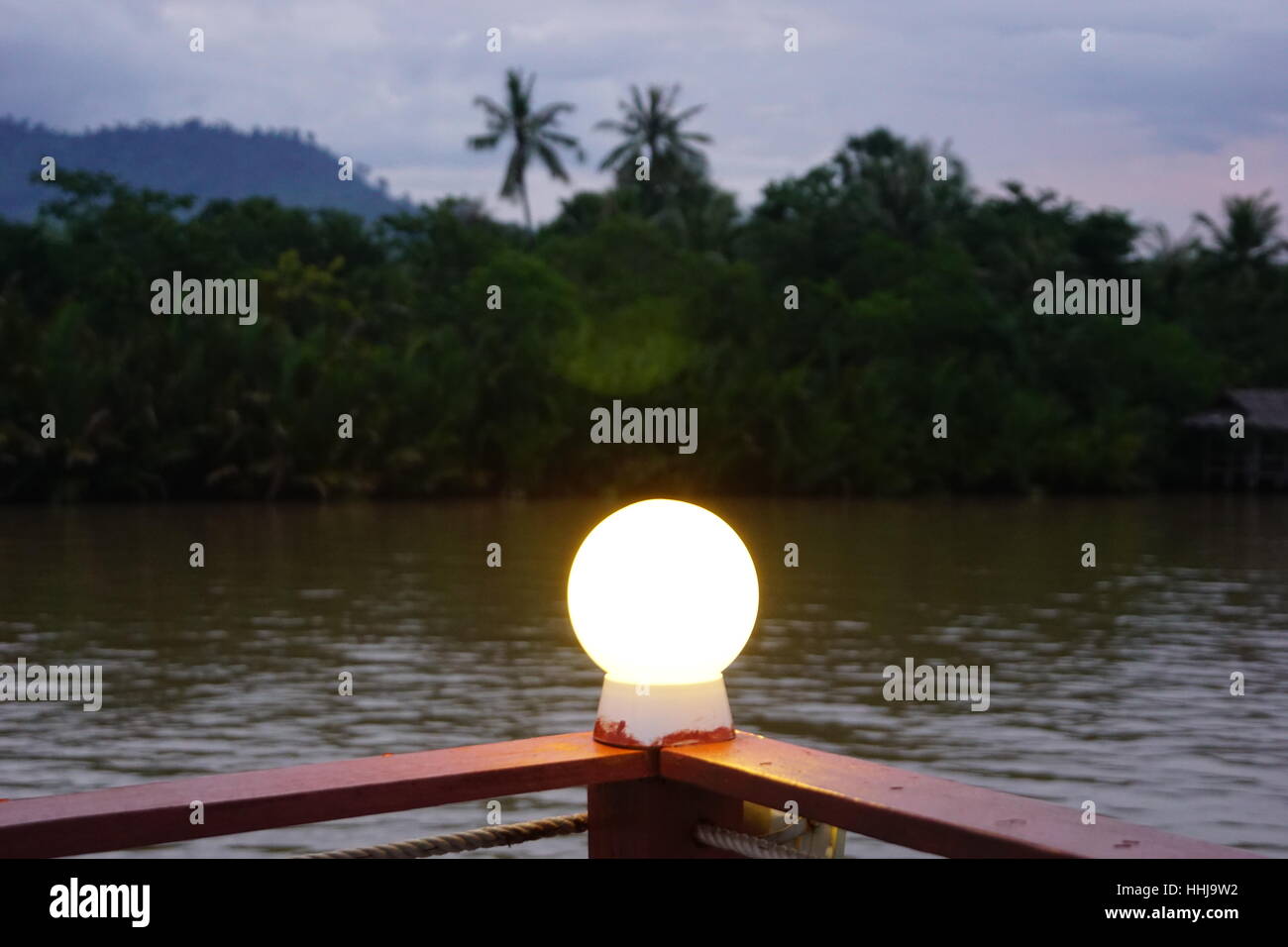 Bright Idea / Light Bulb / Shining Light on the River in Exotic Paradise Kampot Cambodia at Dusk Stock Photo