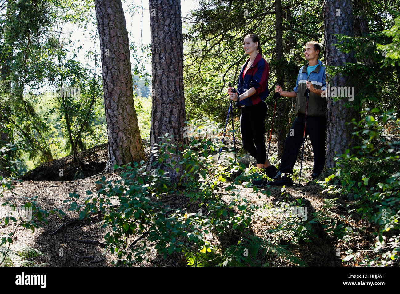 Young couple hiking through forest hi-res stock photography and images ...