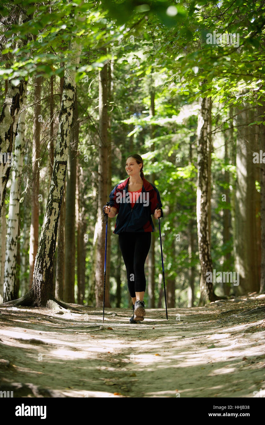 Young woman walking in forest Stock Photo - Alamy