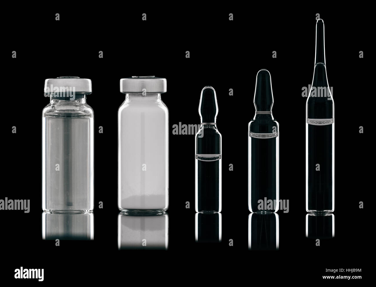 Different types of vials of different liquids. Isolated on a black