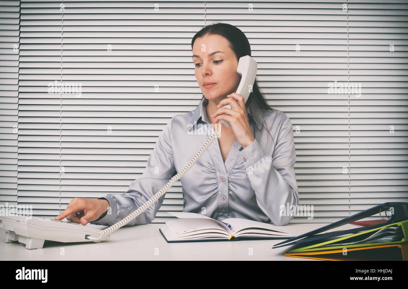 secretary on the phone at office. Businesswoman Stock Photo