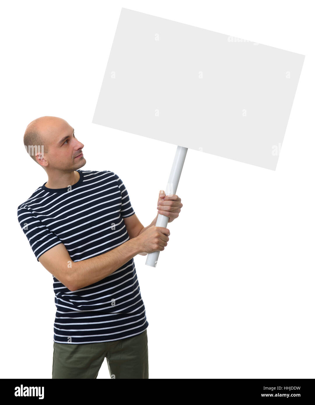 Casual young man holding a placard, looking up. Studio isolated Stock Photo