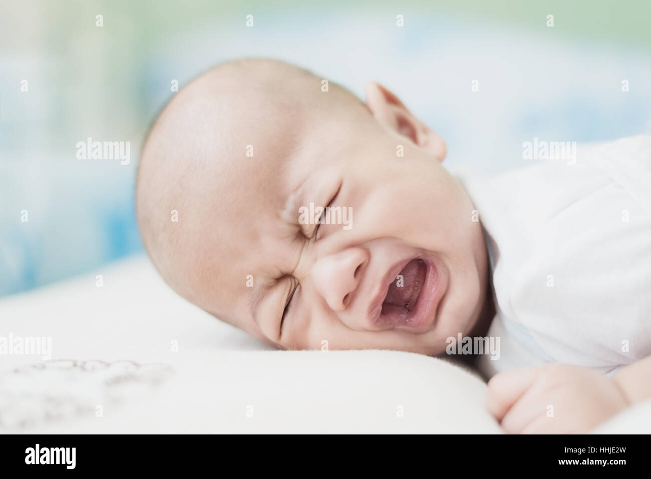 Portrait of 3 months Asian baby boy crying in bedroom. Stock Photo