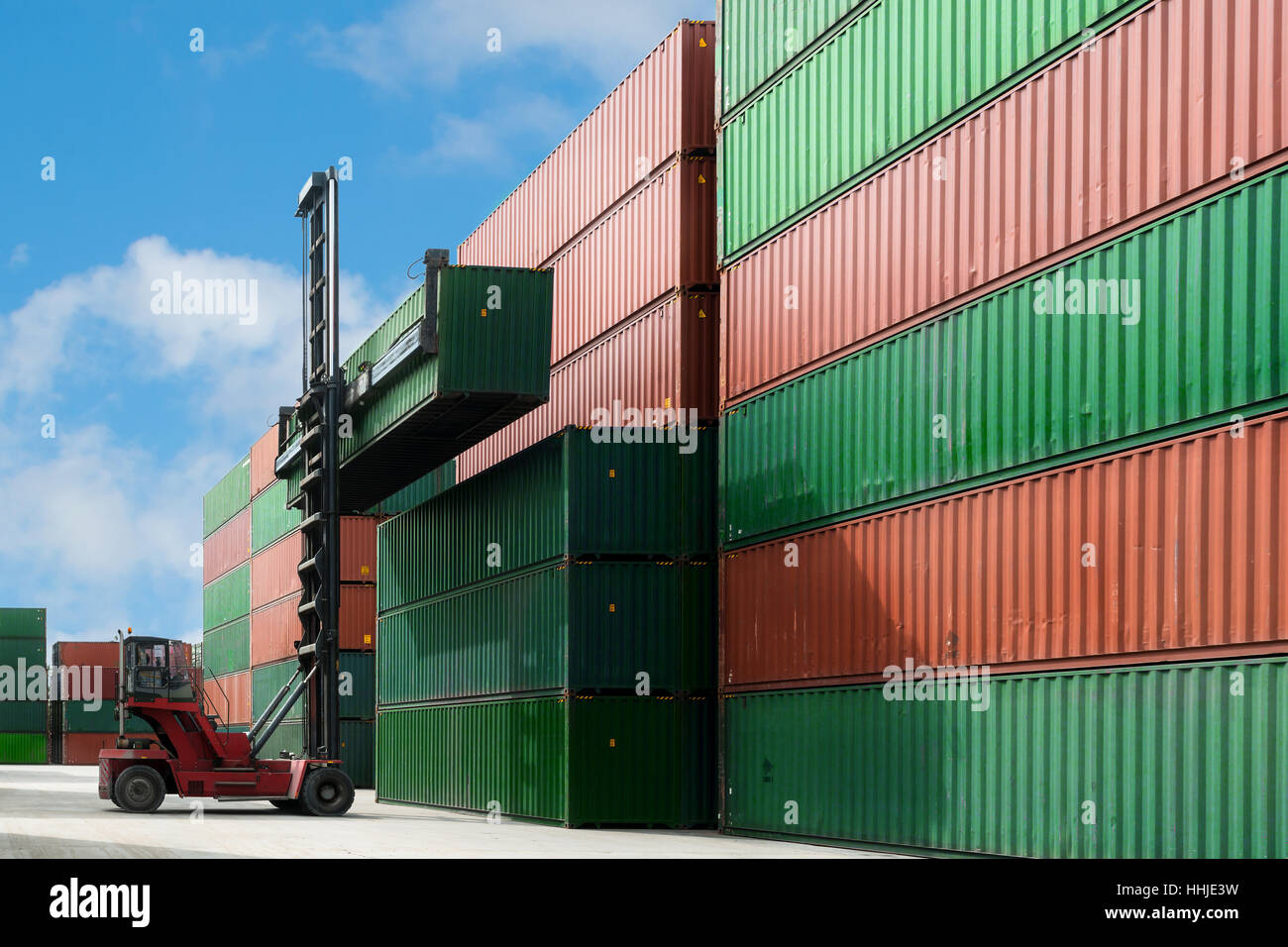 Crane lift up container box loading to container depot use for cargo import, export, logistics background. Stock Photo