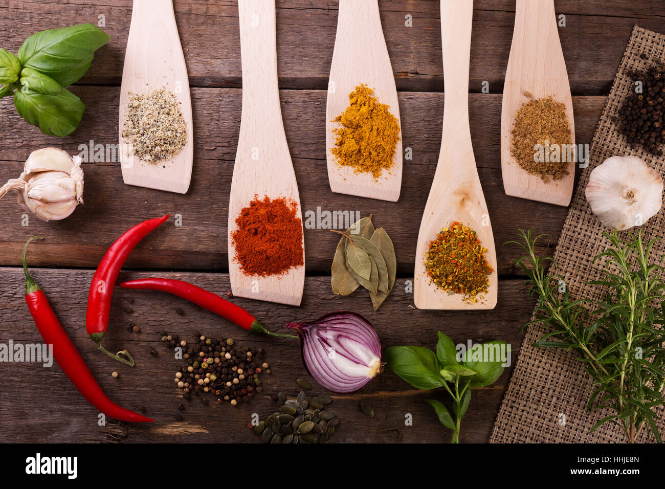 top view of herbs and spices on wooden board Stock Photo