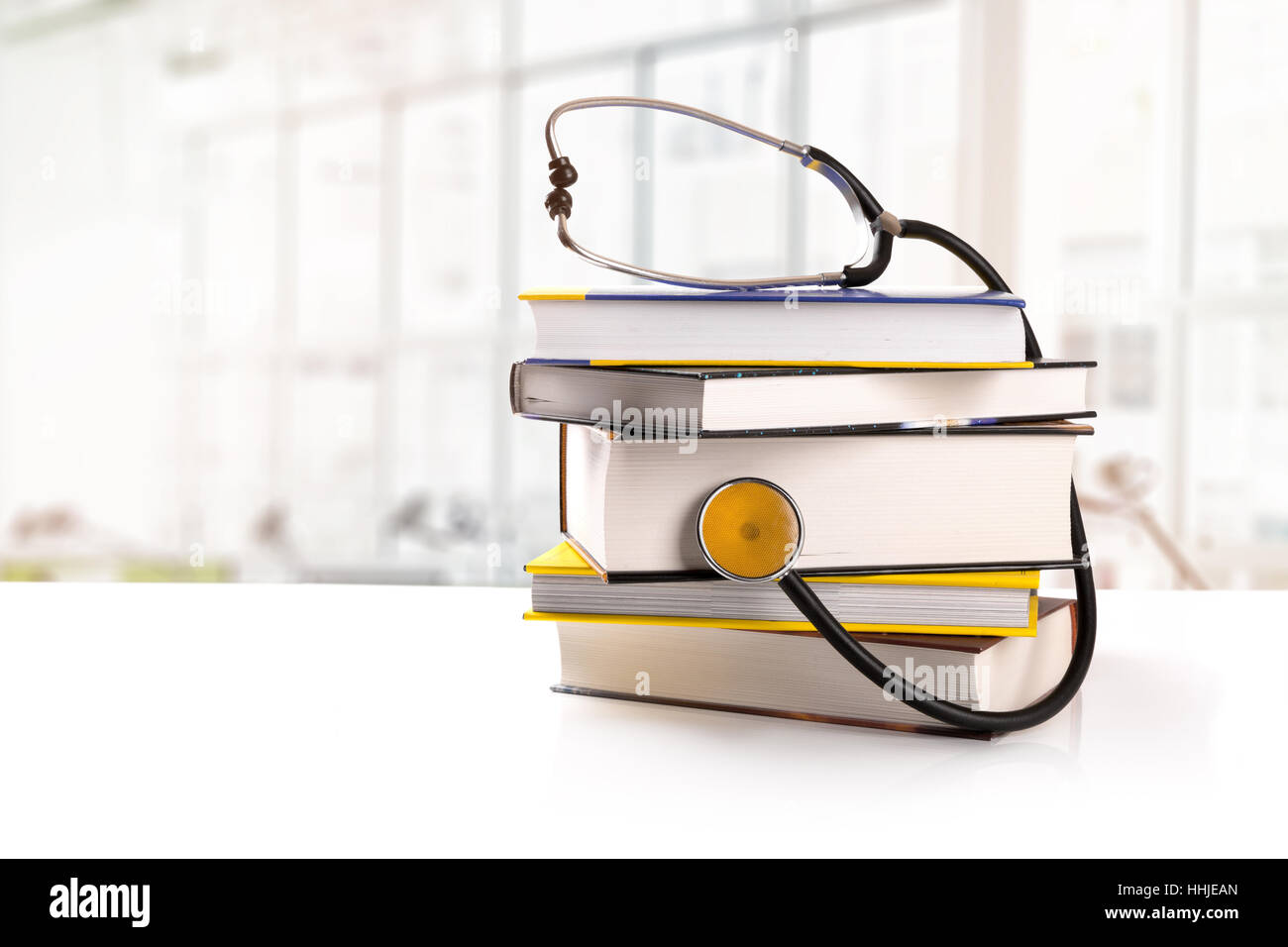 medical education - stack of books with stethoscope on the table in library Stock Photo