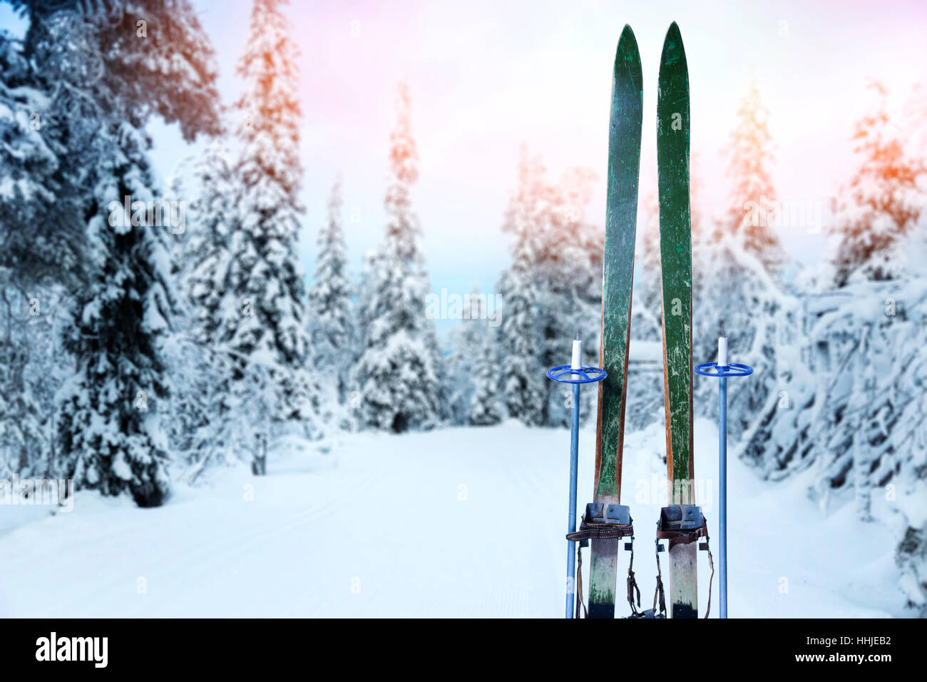 snowy cross country ski trail with retro wood skis and ski poles Stock Photo