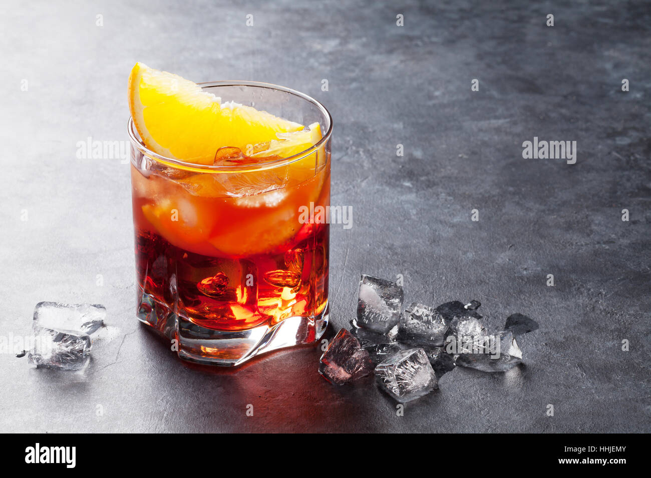 Negroni cocktail on dark stone table. With space for your text Stock Photo