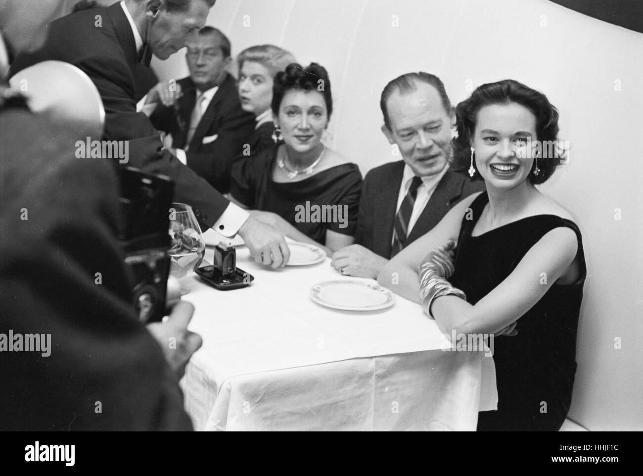 Gloria Vanderbilt, at dinner with friends, 1955. Stock Photo