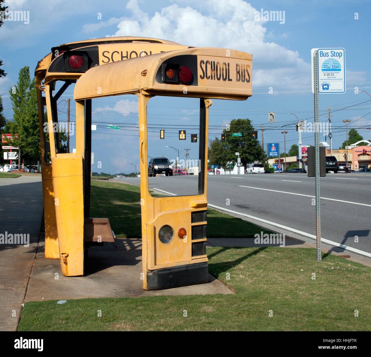 In Athens, Georgia, an old school bus has been transformed into a quirky bus shelter, blending function with roadside creativity. Stock Photo