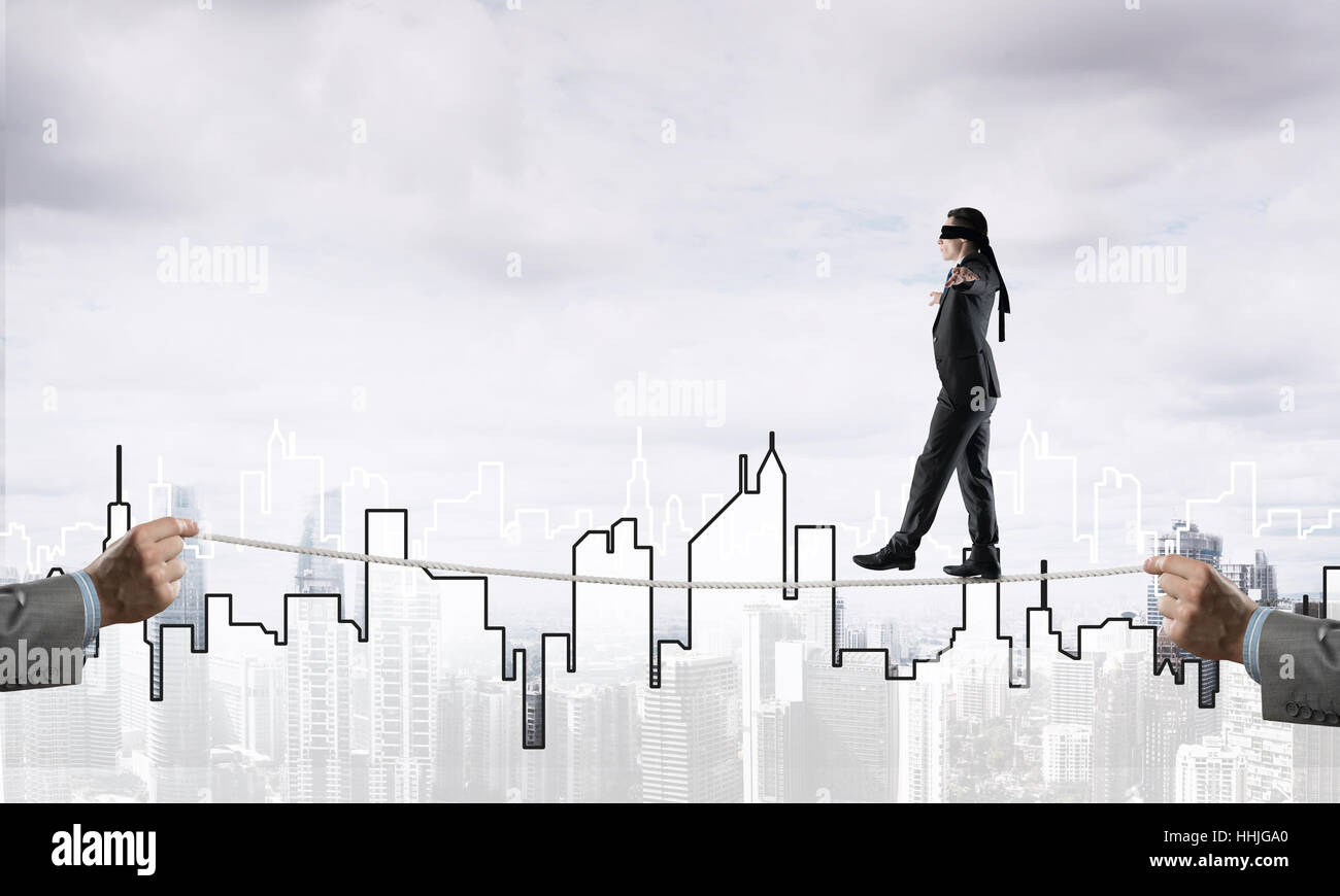 Business concept of risk support and assistance with man balancing on ...