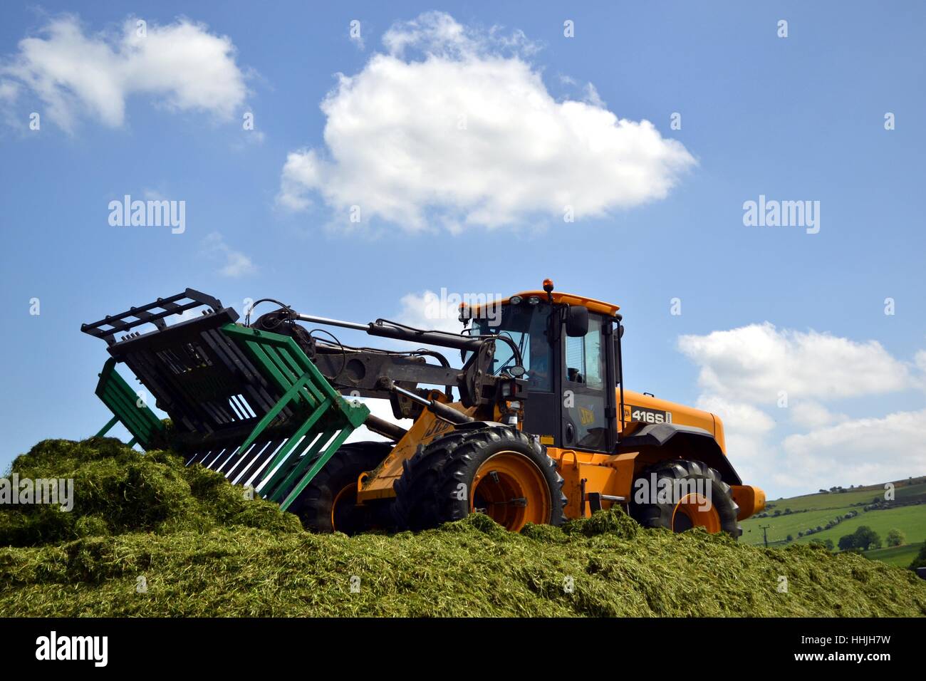 loader on the silage pit Stock Photo