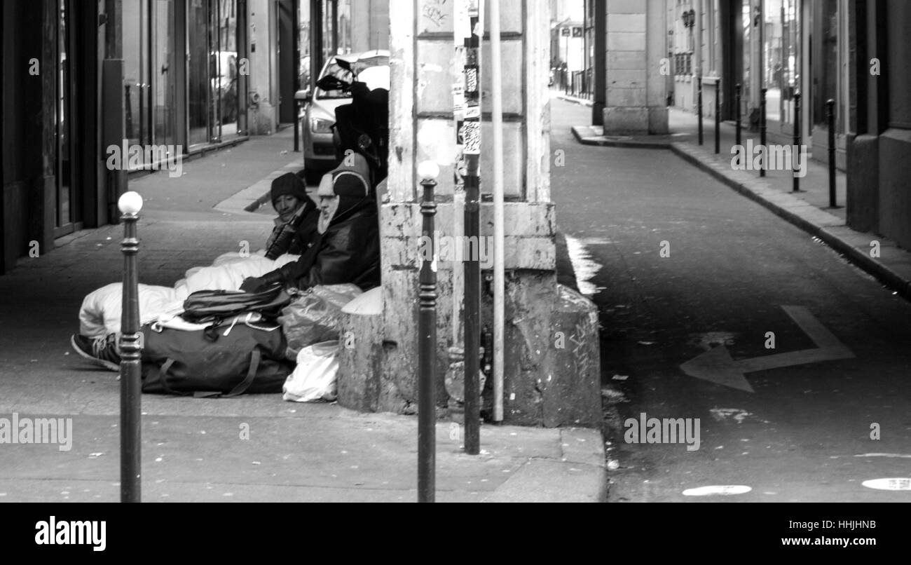 Three men sleeping on streets in Paris Stock Photo