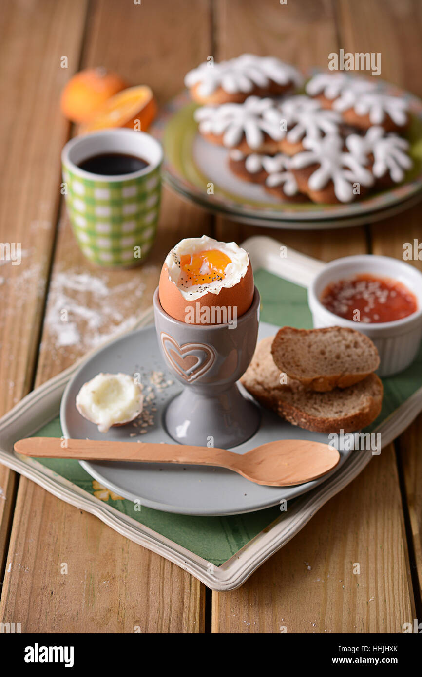 soft-boiled egg with slices of bread for breakfast on the wooden table Stock Photo