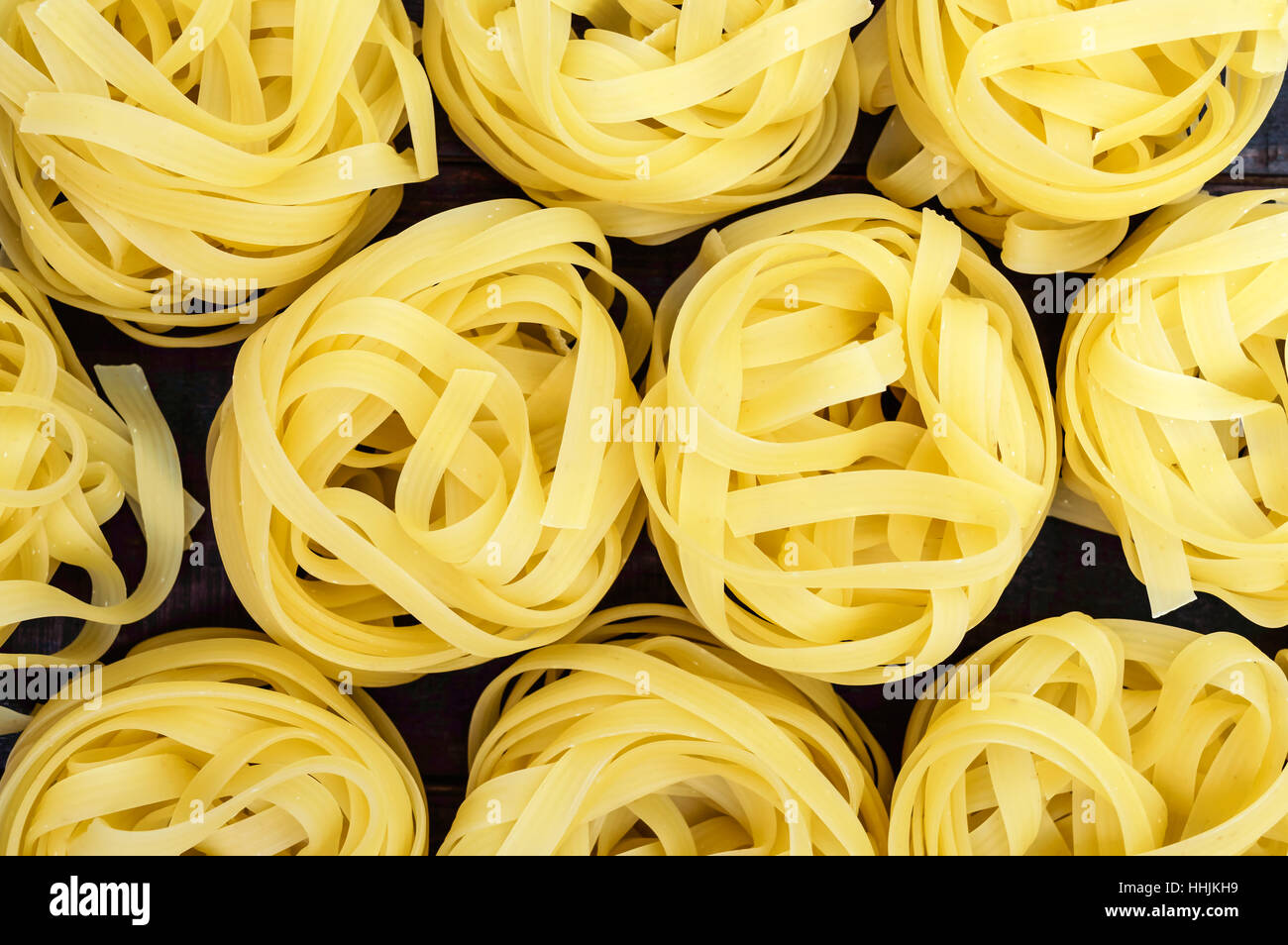 Pasta tagliatelle in the form of nests. Food background. The top view