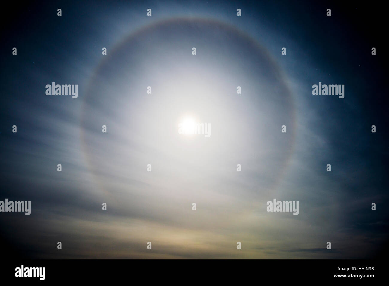 Halo moon, caused by ice particles high in the atmosphere Stock Photo