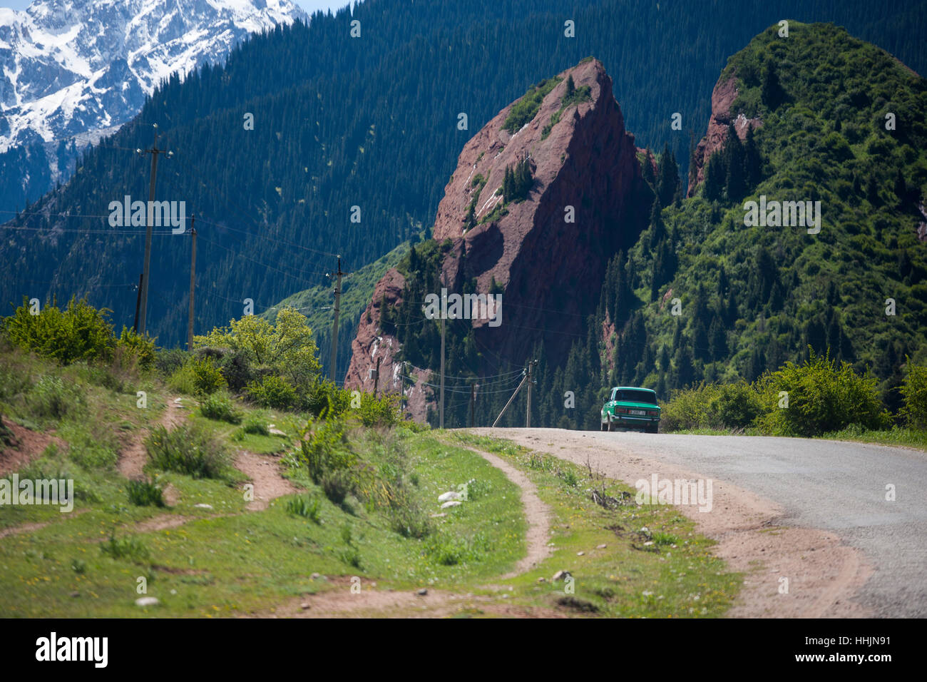 Driving towards Jeti-Ögüz Rocks or Seven Bulls, famous rock formation of Issyk-Kul Region, madeof  Sandstone , close to Karakol Stock Photo