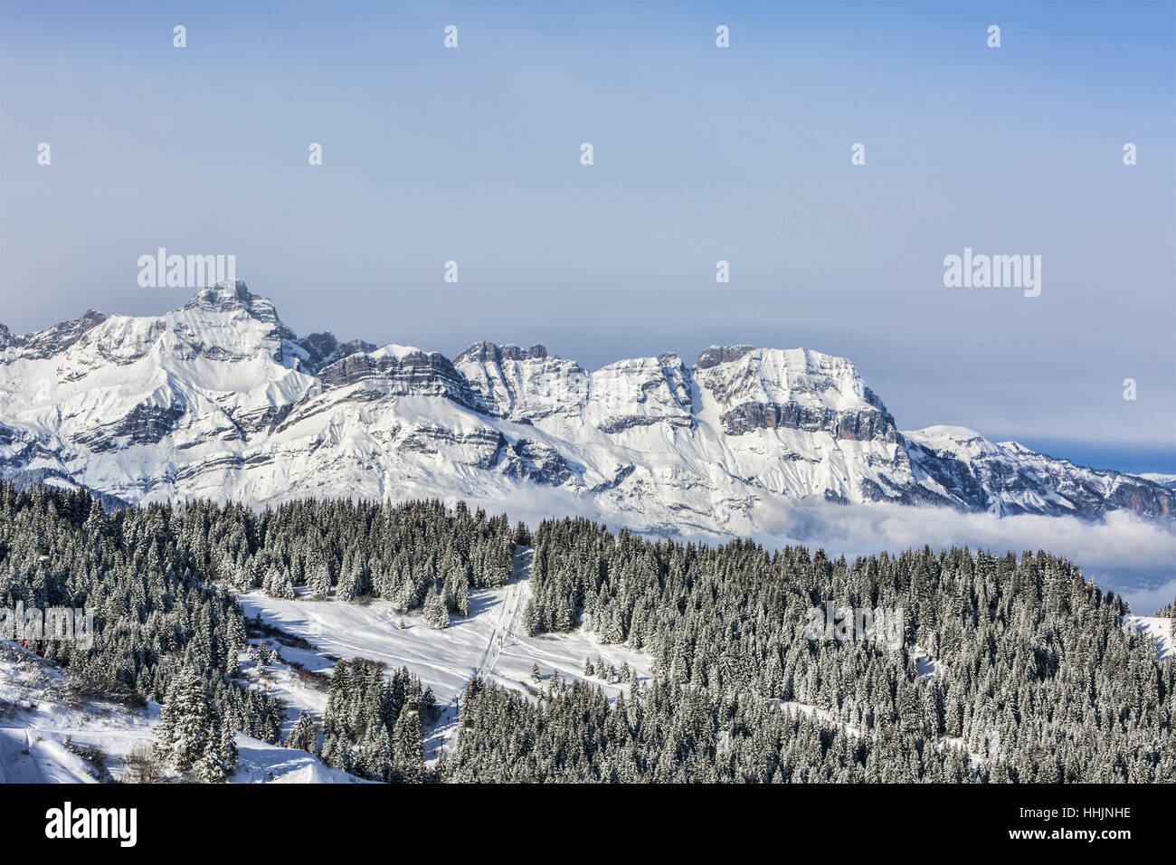 Beautiful winter landscape in the Mont Blanc Massif with the view to the Chaine des Aravis above the clouds and villages. Stock Photo