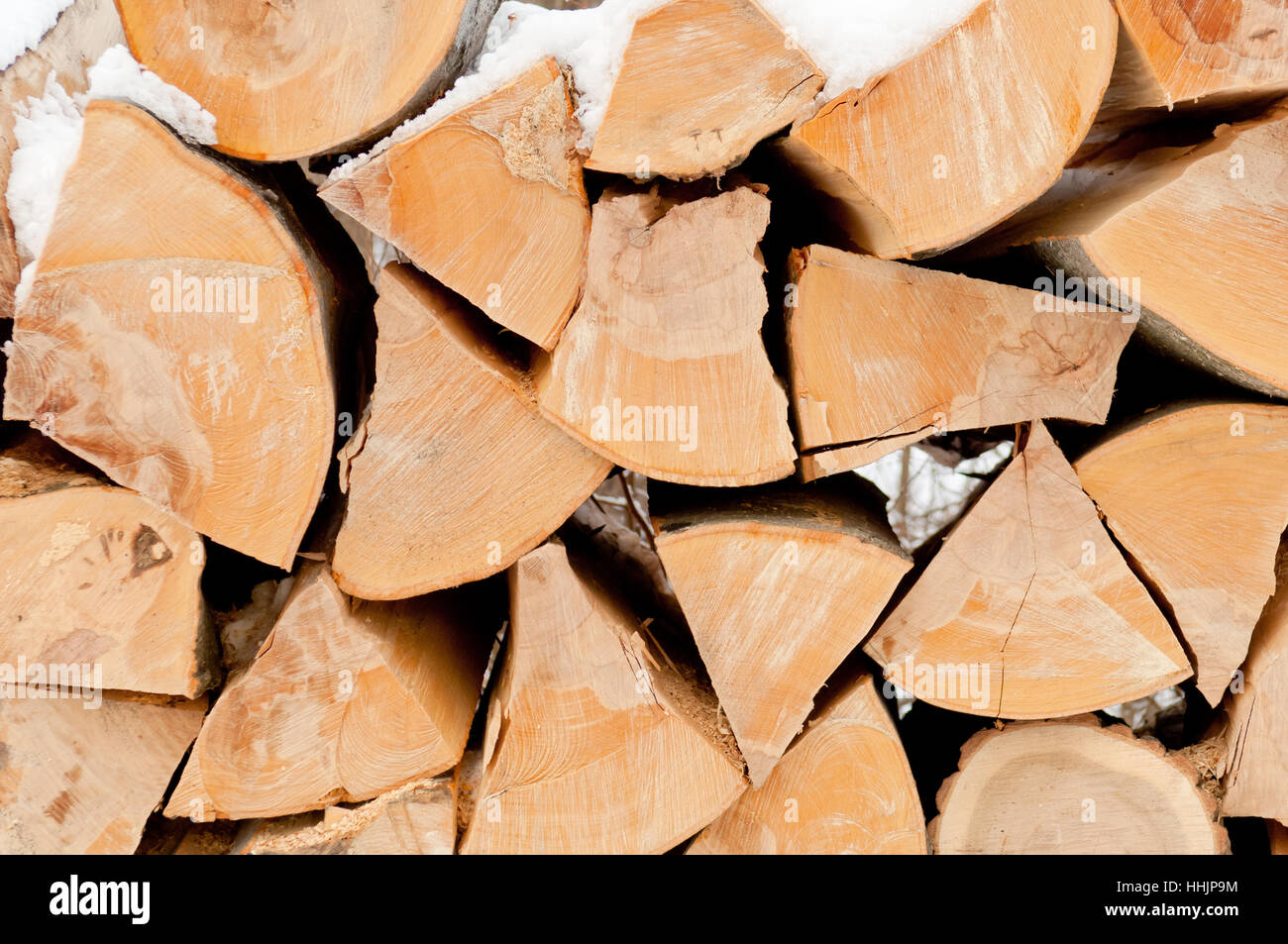Natural wooden background, chopped firewood on stack Stock Photo