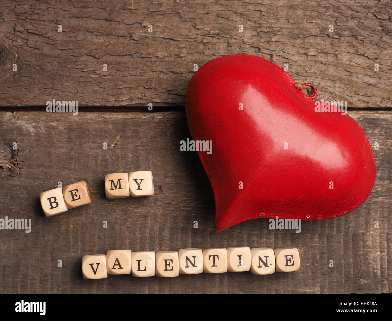 Valentines Day concept background with a red heart shape on a rustic ...