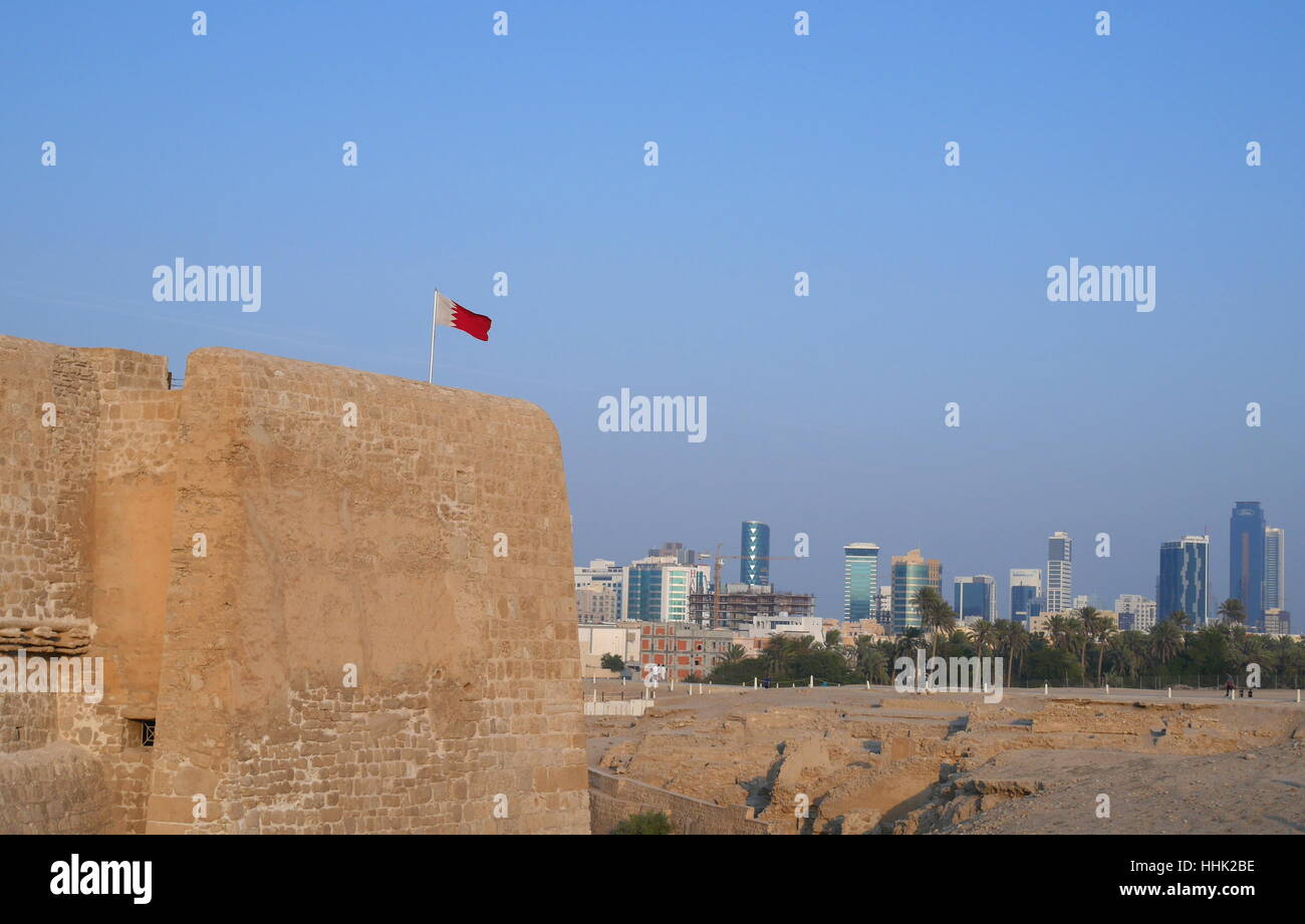 Fortified walls of the Bahrain Fort with the Seef district in the background, Kingdom of Bahrain Stock Photo