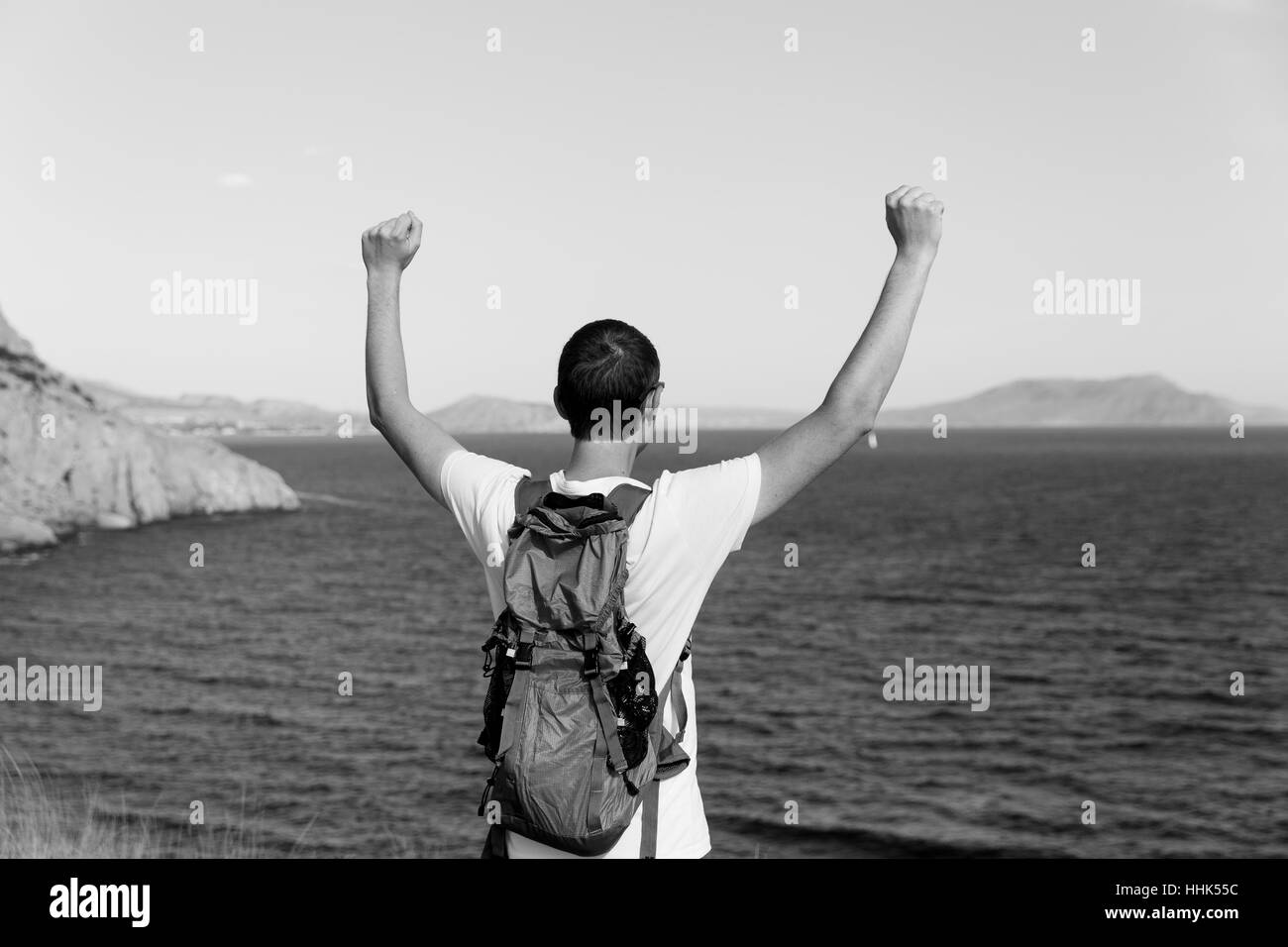 Man with backpack on sea Stock Photo