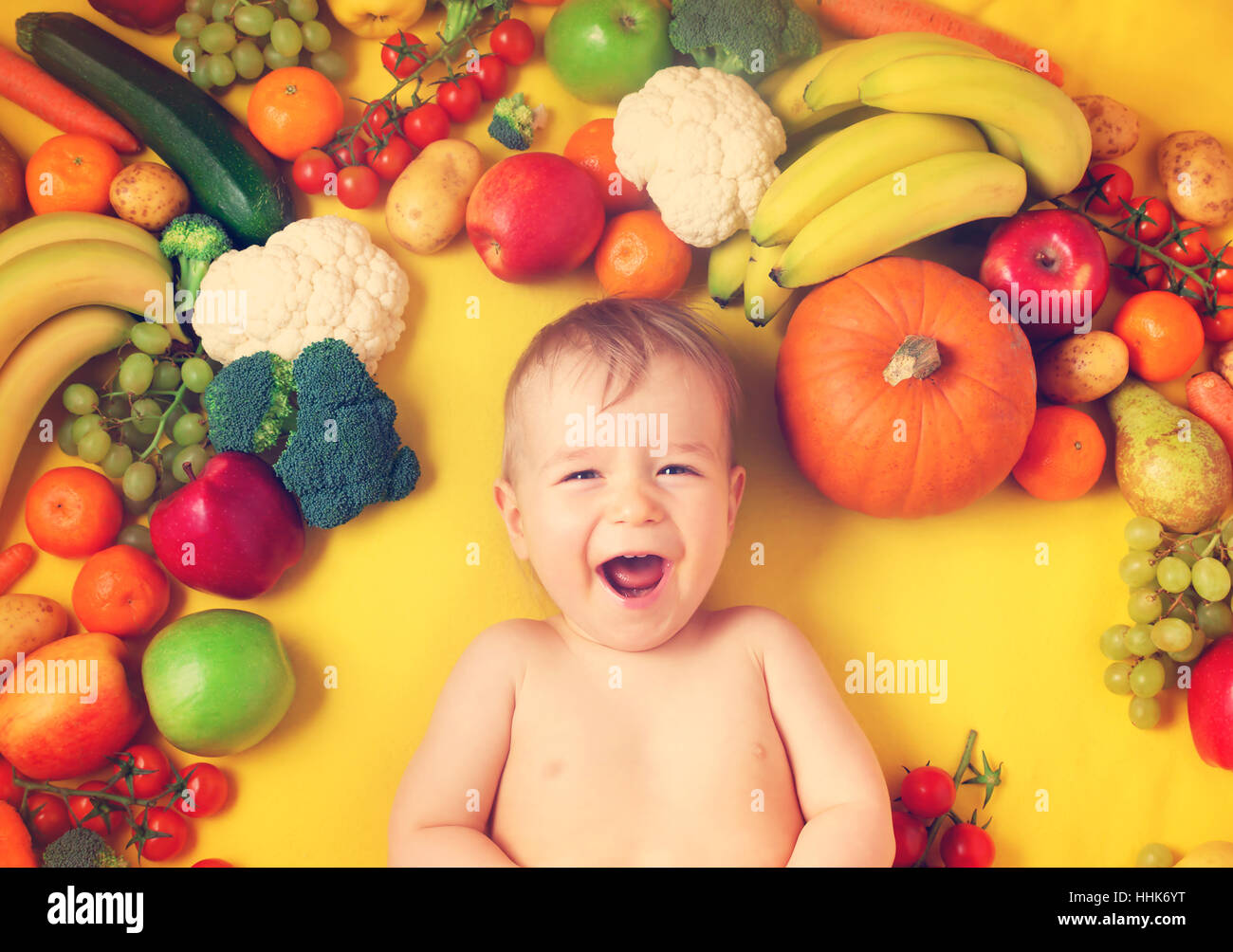 Baby surrounded with fruits and vegetables Stock Photo Alamy