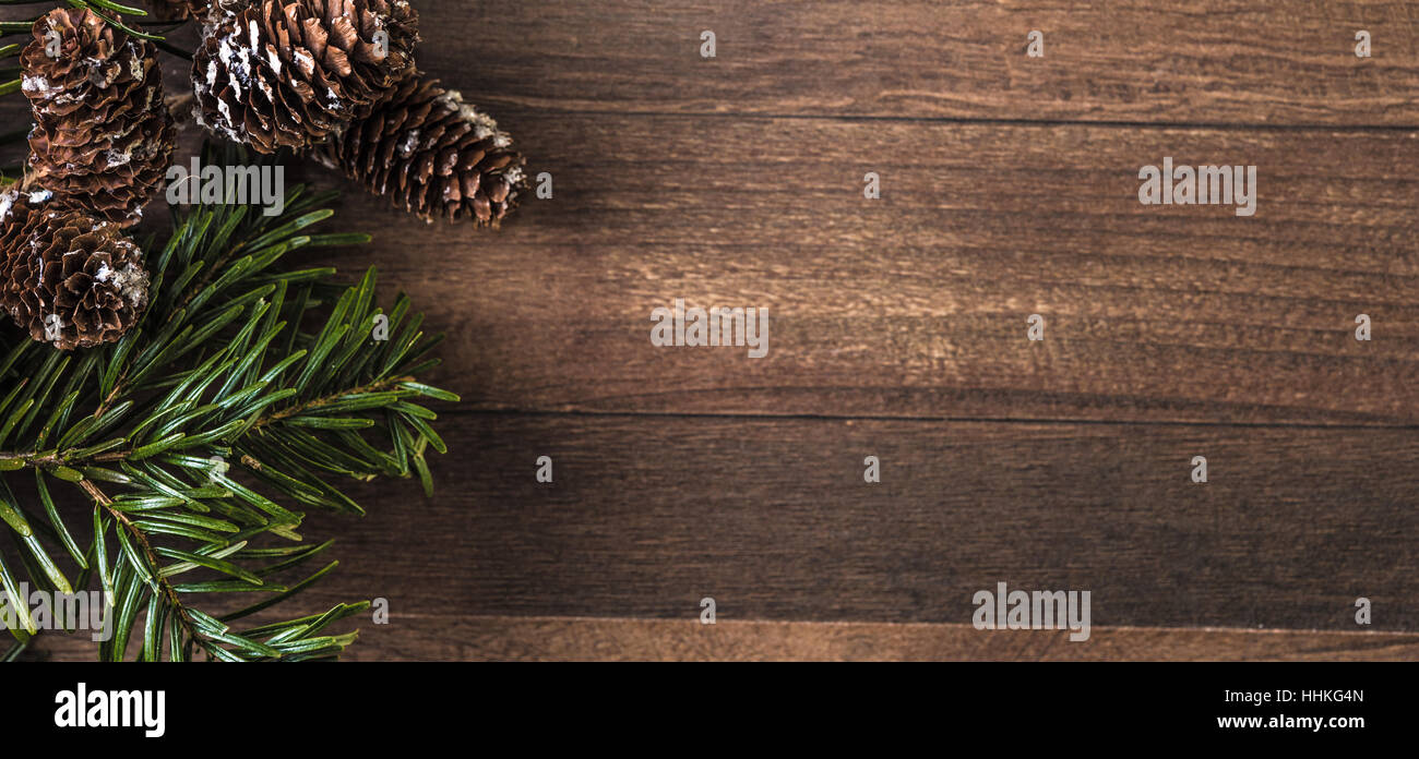 pine cones and fir branch on a wood background Stock Photo - Alamy