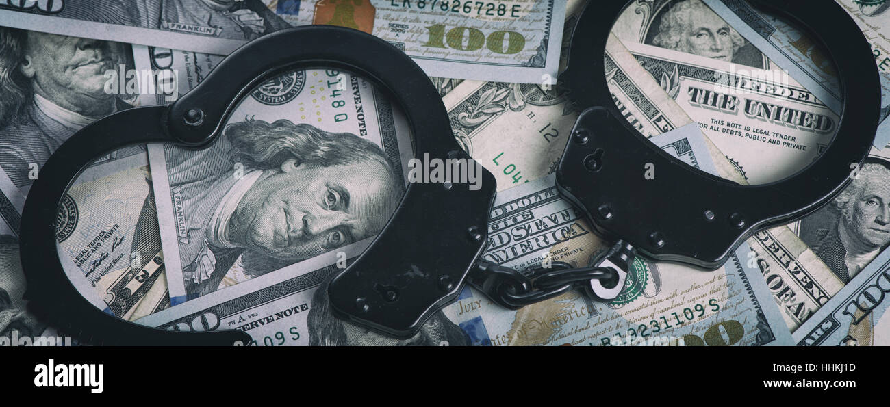 Handcuffs on money. US dollars. Top view Stock Photo
