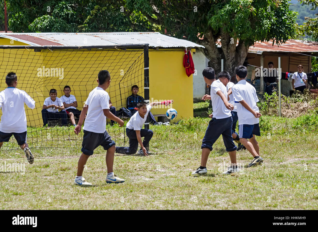 Some students from the school of Kamarata, located in the national park Canaima, Venezuela play a soccer game, in their field of sports having backgro Stock Photo