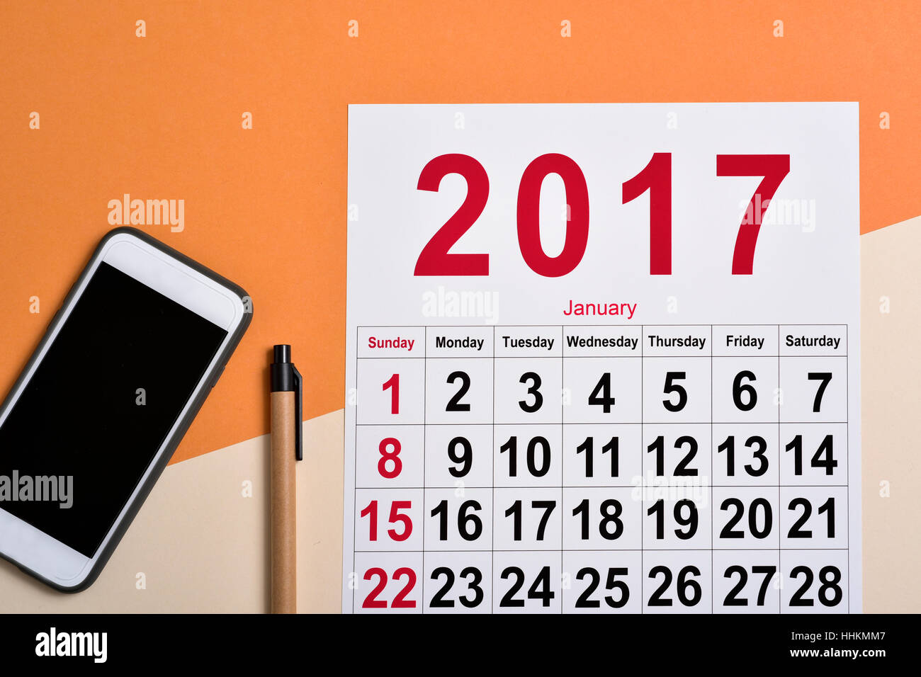 high-angle shot of a 2017 calendar, a smartphone and a pen on a desk Stock Photo