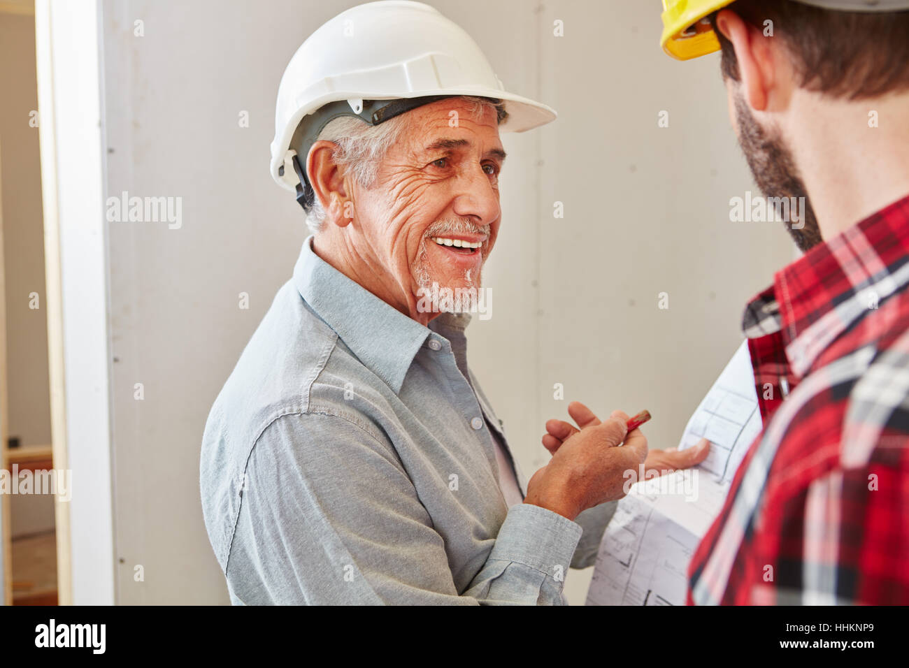 Senior citizen as craftsman with experience cooperating with foreman Stock Photo