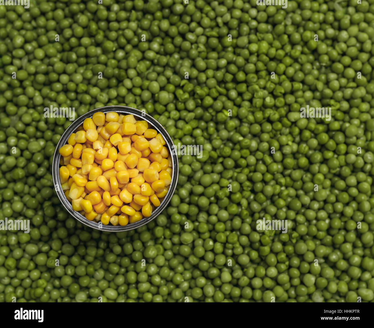 background of peas and corn laid by hand. remove debris . canned peas