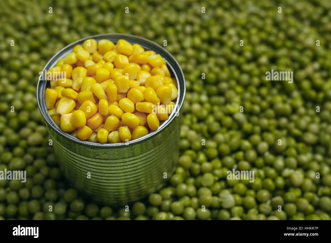 background of peas and corn laid by hand. remove debris . canned peas