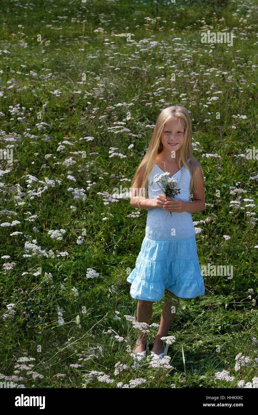 little girl with bouquet in meadow of flowers Stock Photo - Alamy