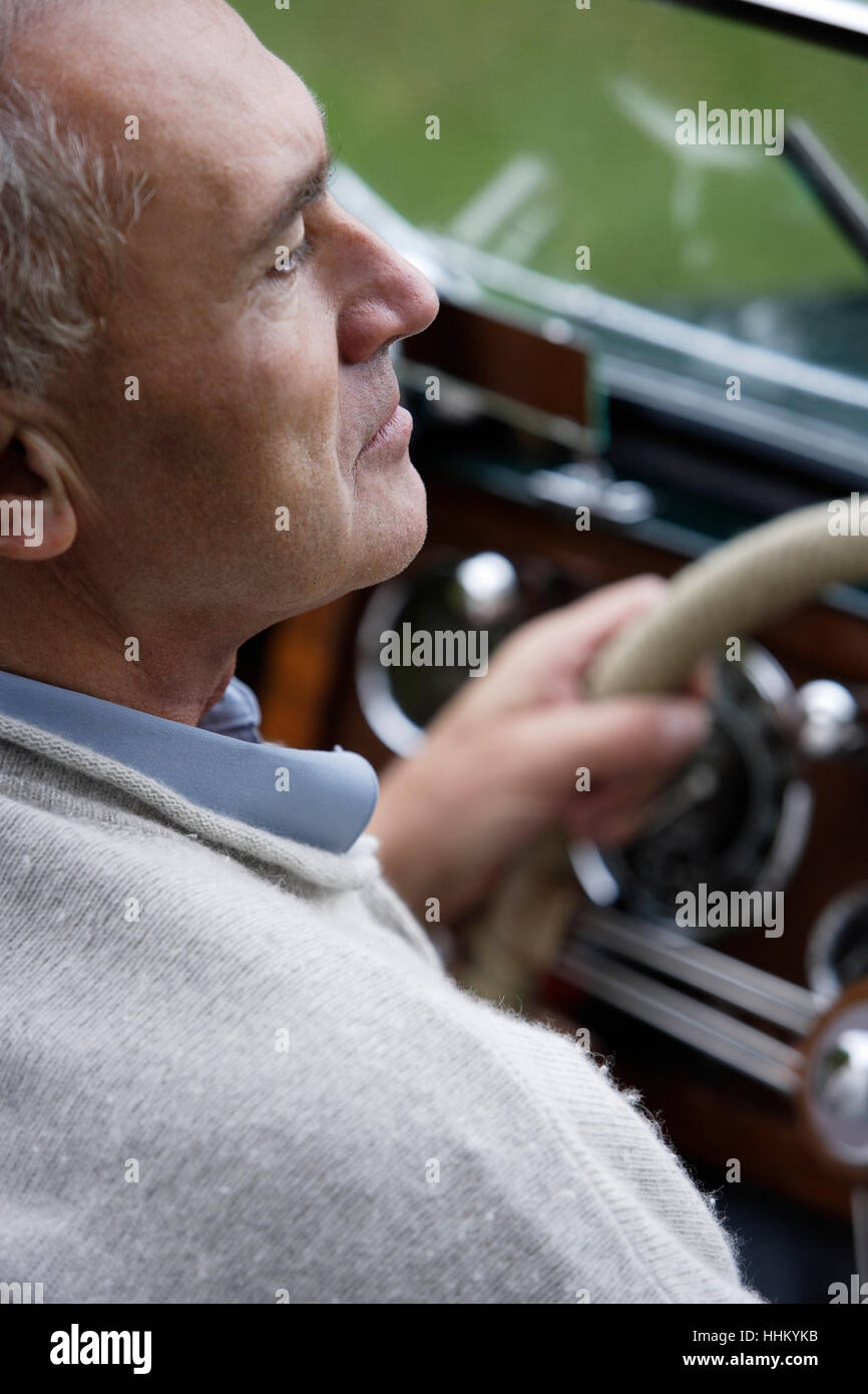 Profile of senior man driving car Stock Photo - Alamy