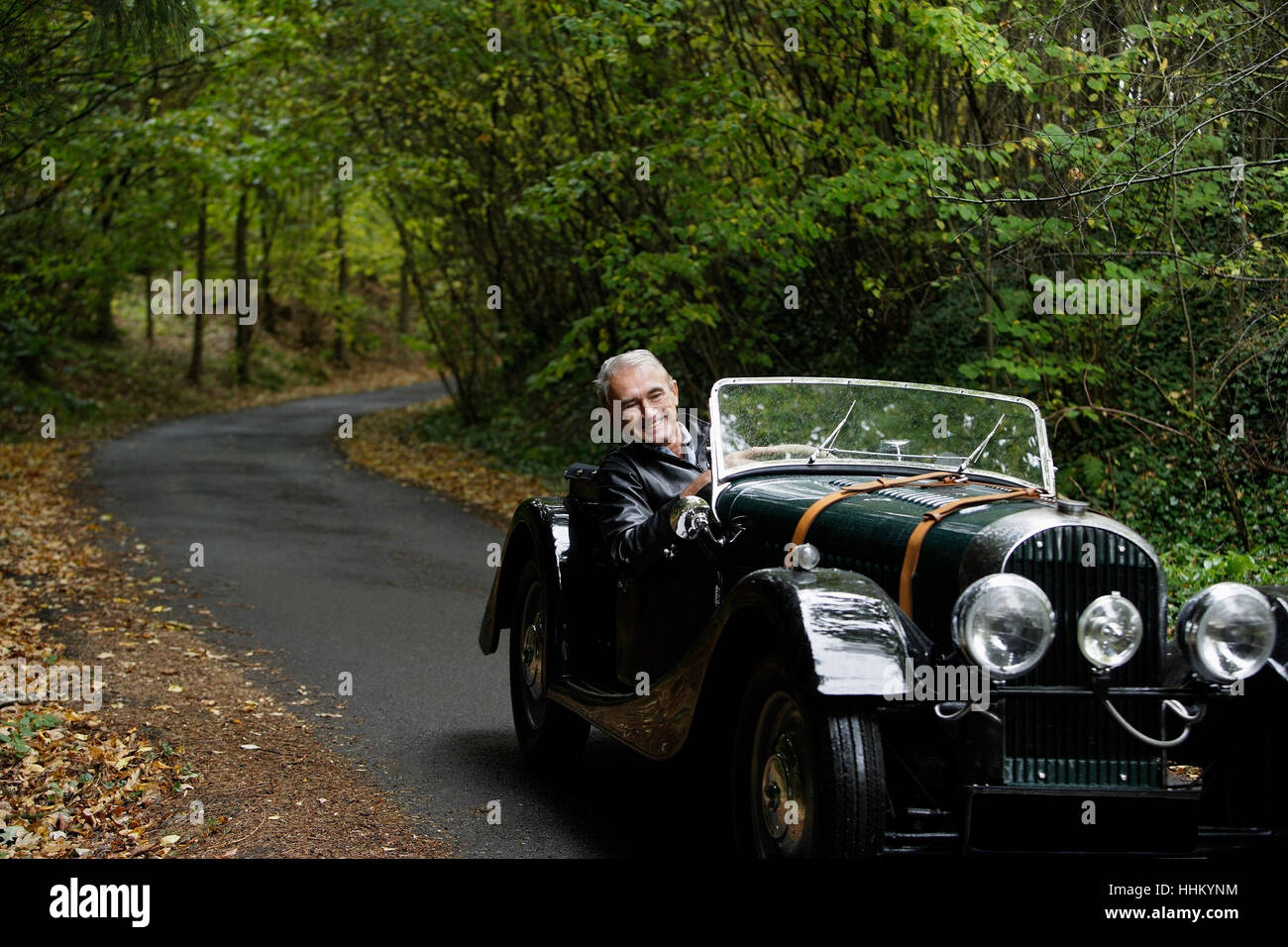 senior man driving in antique car Stock Photo