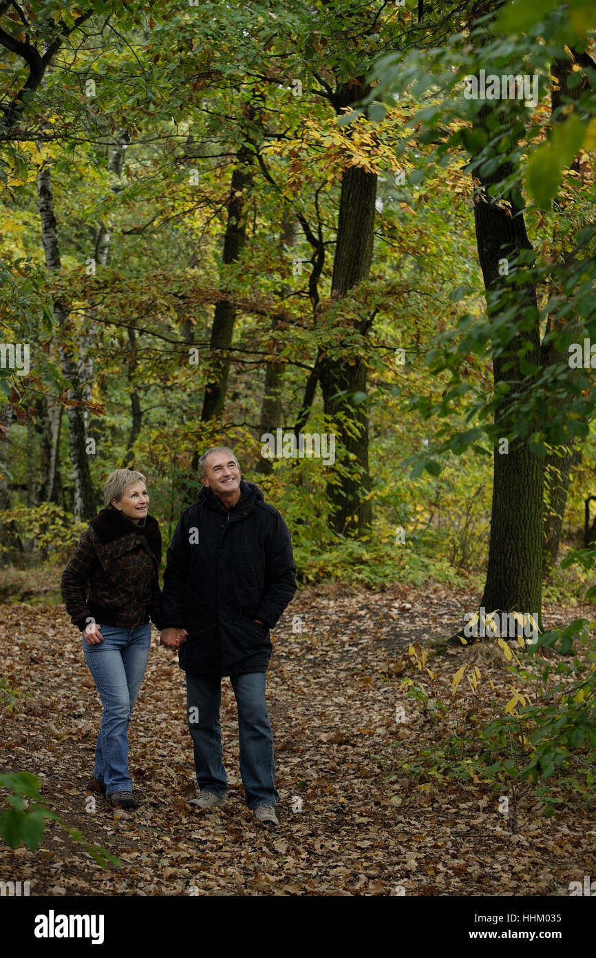 Senior couple on walk through woods Stock Photo - Alamy