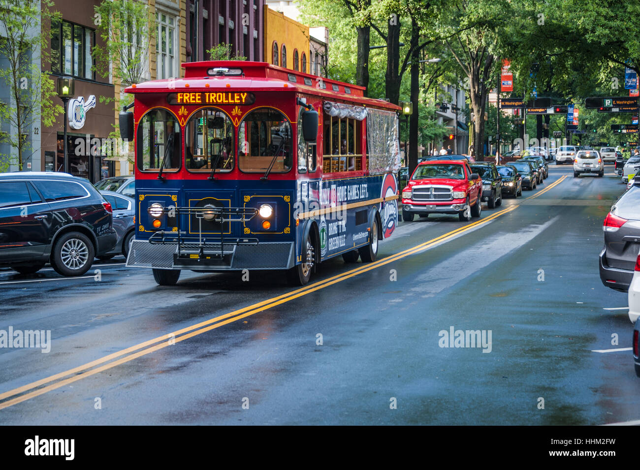 Free trolley transportation on beautiful tree-lined Main Street in historic downtown Greenville, South Carolina, USA. Stock Photo