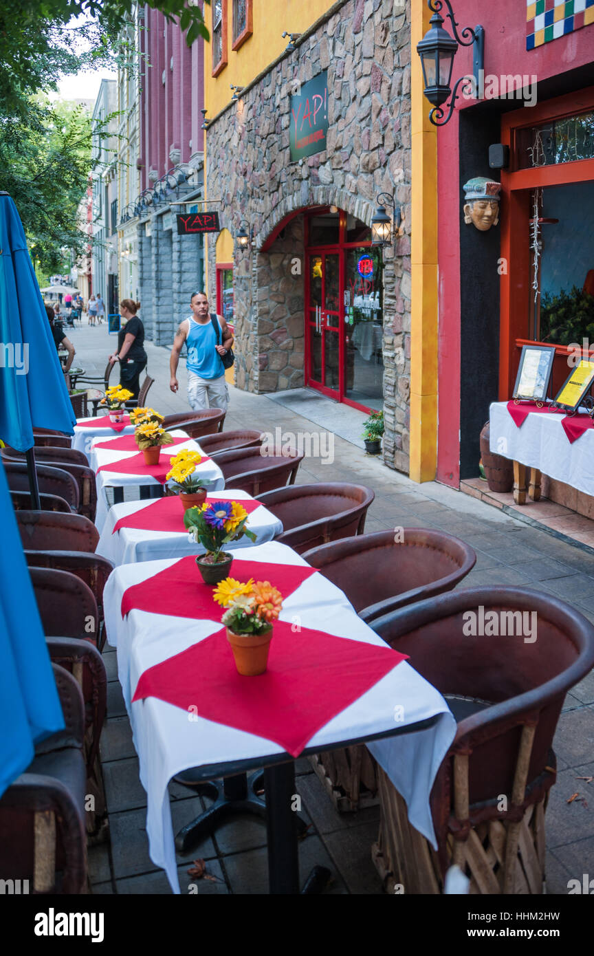 Outdoor sidewalk dining along beautiful treelined Main Street in downtown Greenville, South