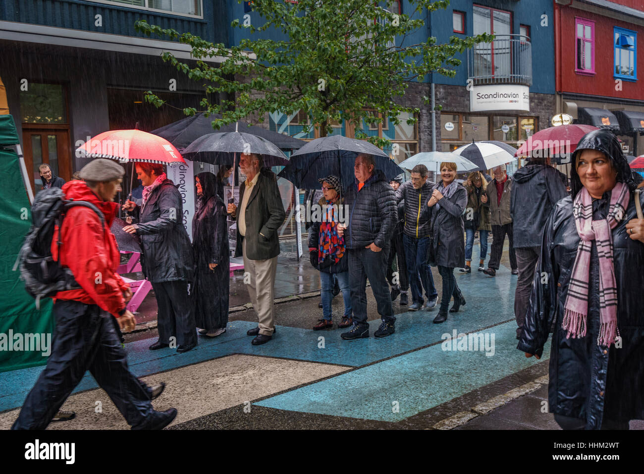 Crowds walking downtown on rainy day,. Cultural Festival known as Menningarnott, Reykjavik, Iceland. Stock Photo